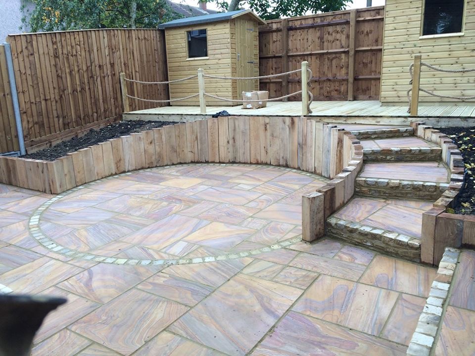 Decking with curved steps and radial sandstone sett design – full garden landscaping in Aylesbury