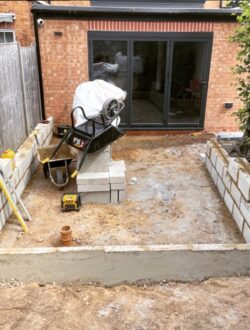 Smooth rendered wall installation providing structure and style to garden levels