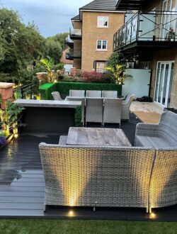 Modern outdoor seating area with composite decking and integrated lighting – Rickmansworth