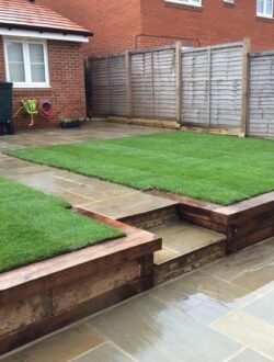 Newly laid sandstone patio and fresh lawn installation